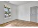 Cozy bedroom features a large window for natural light, neutral paint, and durable wood-look floors at 3085 Jackson St, Hapeville, GA 30354