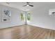 Bright bedroom with three windows, hardwood floors, white walls and a ceiling fan at 3085 Jackson St, Hapeville, GA 30354