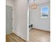 Bright foyer with light wood floors and bench offers convenient storage at 3085 Jackson St, Hapeville, GA 30354