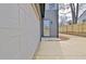 Side view of a detached garage with an adjacent entry door and extended driveway at 3085 Jackson St, Hapeville, GA 30354