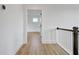 Bright hallway featuring hardwood floors, white walls, and an inviting view into another room at 3085 Jackson St, Hapeville, GA 30354