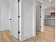 Hallway with doors leading to rooms showcasing updated paint, modern hardware, and durable floors at 3085 Jackson St, Hapeville, GA 30354