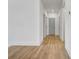 Bright hallway featuring wood-look flooring and neutral paint, leading to other rooms at 3085 Jackson St, Hapeville, GA 30354