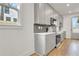 Modern kitchen with gray cabinets, quartz countertops, tiled backsplash, and stainless steel appliances at 3085 Jackson St, Hapeville, GA 30354