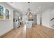 Expansive kitchen featuring modern lighting, a center island, gray cabinets, and hardwood flooring at 3085 Jackson St, Hapeville, GA 30354
