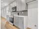 Well-lit kitchen with gray cabinets, stainless steel appliances, and modern countertops and backsplash at 3085 Jackson St, Hapeville, GA 30354