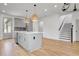 An open kitchen featuring gray cabinets, a center island, pendant lighting, and stainless steel appliances at 3085 Jackson St, Hapeville, GA 30354