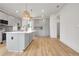 Bright kitchen featuring gray cabinets, a large island, stainless appliances, and hardwood floors at 3085 Jackson St, Hapeville, GA 30354