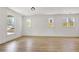 Bright, open living room featuring multiple windows, light wood floors, and white trim at 3085 Jackson St, Hapeville, GA 30354