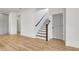 A view of the staircase with a wood banister, white risers, and dark treads at 3085 Jackson St, Hapeville, GA 30354