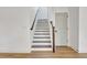 Staircase boasts wood treads, white risers, and stained handrail, showcasing modern design at 3085 Jackson St, Hapeville, GA 30354