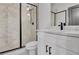 Stylish bathroom featuring white cabinets, a tiled shower, and black hardware at 3163 Old Jonesboro Rd, Hapeville, GA 30354