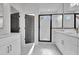 Bright bathroom showcasing double vanity, a marble floor, and a glass-enclosed shower at 3163 Old Jonesboro Rd, Hapeville, GA 30354