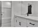 Modern bathroom featuring black hardware, white cabinets, and a tiled floor at 3163 Old Jonesboro Rd, Hapeville, GA 30354