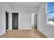 Bedroom with hardwood floors, a window, and a view to other rooms at 3163 Old Jonesboro Rd, Hapeville, GA 30354