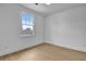 Bright bedroom with light hardwood floors and a large window at 3163 Old Jonesboro Rd, Hapeville, GA 30354