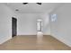 Spacious bedroom with wood floors, white walls, and a hallway leading to the bathroom at 3163 Old Jonesboro Rd, Hapeville, GA 30354