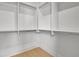 Interior view of a closet featuring white storage shelves and wood floors at 3163 Old Jonesboro Rd, Hapeville, GA 30354