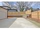 A long driveway that features a two-car garage, a brick retaining wall, and a wooden fence for privacy at 3163 Old Jonesboro Rd, Hapeville, GA 30354