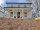 Front elevation of a two-story home with a cozy front porch and craftsman details at 3163 Old Jonesboro Rd, Hapeville, GA 30354