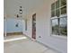 Spacious front porch with a red door, ceiling fans, and ample natural light at 3163 Old Jonesboro Rd, Hapeville, GA 30354