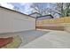 This two-car garage features white siding, a concrete driveway, and a fenced in backyard at 3163 Old Jonesboro Rd, Hapeville, GA 30354