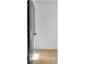 Bright hallway features wood flooring and a gray door, leading into a room with wood flooring at 3163 Old Jonesboro Rd, Hapeville, GA 30354
