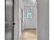 Hallway with wood floors, white walls and black doors, offering a bright, modern look at 3163 Old Jonesboro Rd, Hapeville, GA 30354
