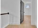 The light-filled hallway showcases wood flooring and a gray door leading to another room with natural light at 3163 Old Jonesboro Rd, Hapeville, GA 30354