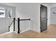 Bright hallway featuring hardwood floors, white walls, and a dark-stained door at 3163 Old Jonesboro Rd, Hapeville, GA 30354