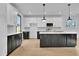 Modern kitchen featuring stainless steel appliances, white cabinets, and dark island at 3163 Old Jonesboro Rd, Hapeville, GA 30354