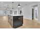 Kitchen island with white countertop, brass hardware and decorative lighting at 3163 Old Jonesboro Rd, Hapeville, GA 30354