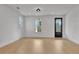 Spacious living room with natural light, wood flooring, and a black entry door at 3163 Old Jonesboro Rd, Hapeville, GA 30354