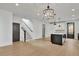 Bright living room with hardwood floors, open staircase and adjacent modern kitchen at 3163 Old Jonesboro Rd, Hapeville, GA 30354