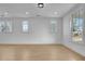 Spacious living room featuring multiple windows and light wood flooring at 3163 Old Jonesboro Rd, Hapeville, GA 30354