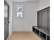 Light filled mudroom with gray built-in bench and storage, wood flooring, and a view to the exterior at 3163 Old Jonesboro Rd, Hapeville, GA 30354