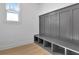 Grey mudroom bench with storage cubbies and wood flooring at 3163 Old Jonesboro Rd, Hapeville, GA 30354