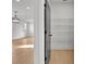 Bright walk-in closet features built-in wire shelving and a view into a large room with a modern chandelier and wood flooring at 3163 Old Jonesboro Rd, Hapeville, GA 30354