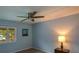 This bedroom features a ceiling fan, a window, and an adjacent picture on the light blue colored wall at 3259 Clairmont North Ne, Brookhaven, GA 30329