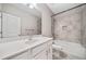 Well-lit bathroom with tile flooring, a sink, and a shower over a tub at 495 Duval Dr, Alpharetta, GA 30009