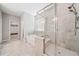 Luxurious bathroom featuring a separate glass shower and a soaking tub beneath a window at 495 Duval Dr, Alpharetta, GA 30009