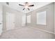 Bedroom with neutral walls, carpeted floors, a ceiling fan, and two windows for natural light at 495 Duval Dr, Alpharetta, GA 30009
