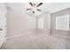 Bedroom with neutral walls, carpeted floors, a ceiling fan, and two windows for natural light at 495 Duval Dr, Alpharetta, GA 30009