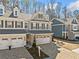 Classic townhome with a brick driveway, neutral siding, and dark shutters at 495 Duval Dr, Alpharetta, GA 30009