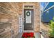 Welcome sign and wreath adorn the front door of this lovely townhome at 495 Duval Dr, Alpharetta, GA 30009