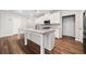 Bright kitchen features a large island with granite countertops and stainless steel appliances at 495 Duval Dr, Alpharetta, GA 30009