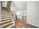 Open-concept living space with hardwood floors, staircase, and abundant natural light at 495 Duval Dr, Alpharetta, GA 30009
