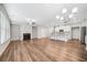 Open-concept living area with fireplace and a view of the modern kitchen at 495 Duval Dr, Alpharetta, GA 30009