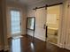 En-suite bathroom featuring a white sliding barn door and view of the shower at 6121 Gordy Ne St, Covington, GA 30014