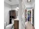 Modern bathroom with a toilet, vanity, mirror, and a barn door entry to a closet at 681 Home Se Ave, Atlanta, GA 30312